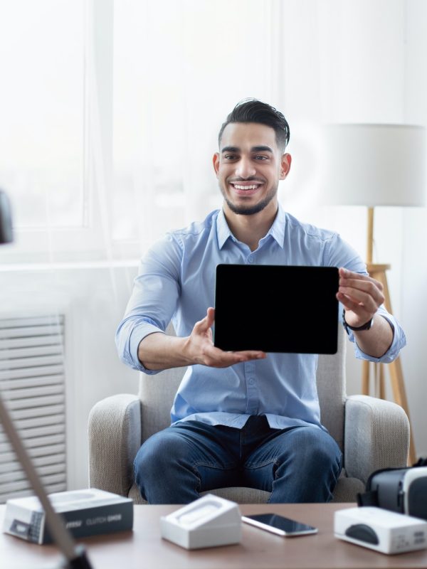digibasera-male-influencer-shooting-video-review-of-modern-tablet-computer-on-professional-dslr-camera-at.jpg